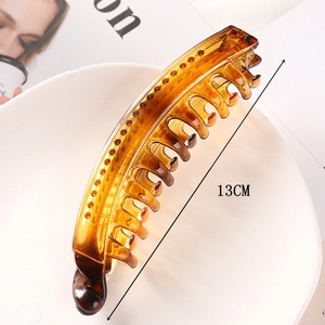 Close-up of 13CM large brown hair claw clip on white plate with size measurement text