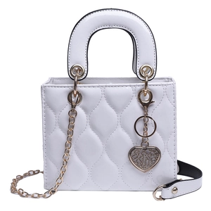 White glossy patent leather lady bag with diamond quilting and heart pendant
