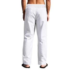 Detail view of white linen pants featuring elastic waistband and breathable fabric texture