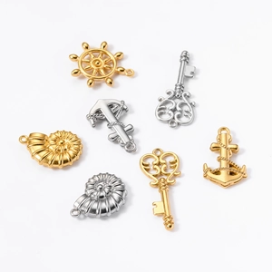 Detailed flat lay of vintage nautical stainless steel charms in gold and silver finishes