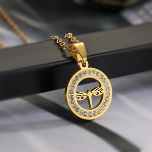 Macro shot of gold-plated dragonfly pendant necklace with sparkling crystal rhinestones