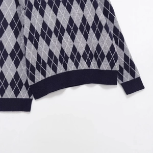 Women's V-neck knit sweater featuring a grey and navy argyle pattern and ribbed cuffs