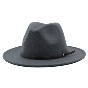 Detail of dark grey fedora hat with flat brim and black leather belt featuring gold studs