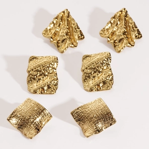 Three pairs of irregular geometric gold stainless steel stud earrings with textured finish