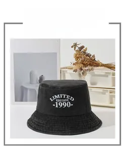 Close-up of white limited edition 1990 embroidery on a washed cotton bucket hat