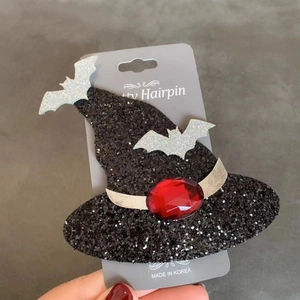 Halloween glittery black witch hat hair clip with silver bats and a red gemstone decor