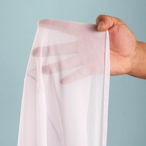 Close-up of white breathable mesh fabric showing fine texture and sheer transparency