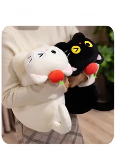 Detail of plush cat dolls in black and white with soft fur and embroidery crafts