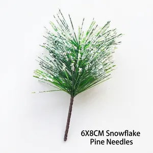 Detail of 6x8cm artificial pine needles branch with white flocked snow for DIY decor