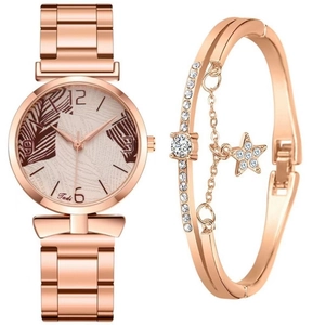 Detail of rose gold quartz watch with palm leaf dial and sparkling star bracelet