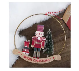 Detail of wooden Nutcracker ornament in metal ring with Merry Christmas sign