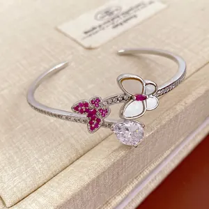 Silver open bracelet with pink zircon butterfly and teardrop stone on jewelry box