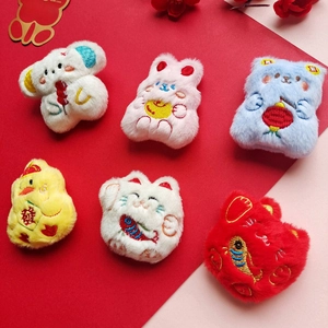 Close-up of plush cartoon brooches with embroidery details and festive motifs