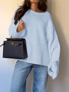 Detail of light blue loose knit sweater texture with comfortable soft material