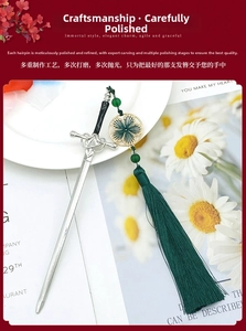 Detail of silver sword hairpin with green beads and long silk tassel on a white plate