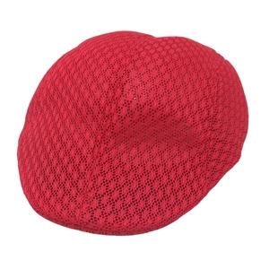 Detailed view of red lace mesh newsboy cap featuring intricate hollow-out floral patterns