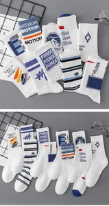 Detailed view of white cotton mid-calf sports socks with retro athletic stripes and logos