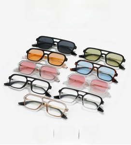 Detailed overhead view of multiple retro square frame aviator sunglasses in various colors