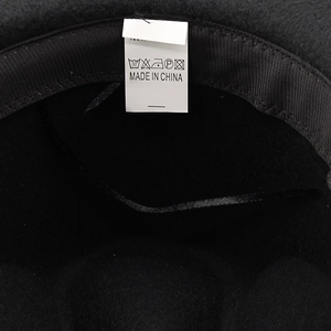 Detail view of the black cowboy hat interior showing the sweatband and white care label