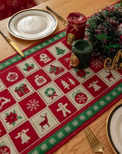 Detail of Christmas table runner with jacquard woven reindeer and festive patterns