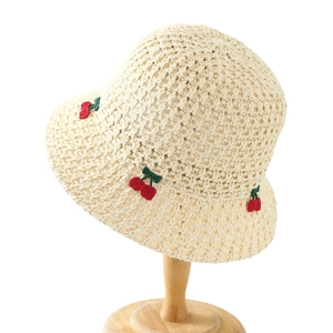 Handcrafted crochet straw hat with red cherry embroidery and elegant wavy brim