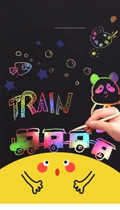 Detail of wooden stylus scratching vibrant rainbow patterns on black scratch cards