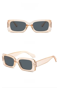 Close-up of square sunglasses with transparent tea-colored frames and dark grey lenses