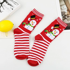 Detail of red Christmas socks featuring cute snowman patterns and striped sole design