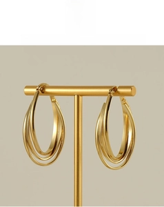 Macro view of triple-layered 18k gold plated stainless steel hoops with polished finish
