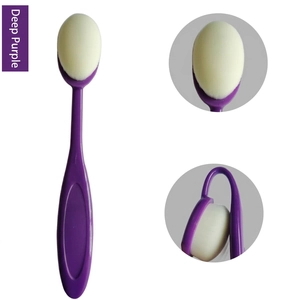 Deep purple oval foundation brush with soft white bristles and flexible handle design