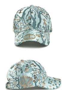 Detailed embroidery view of ethnic style blue satin baseball cap with traditional patterns