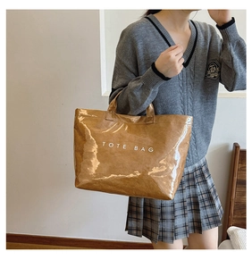 Brown Dupont paper tote bag with large capacity and shiny finish shown in a stylish setup