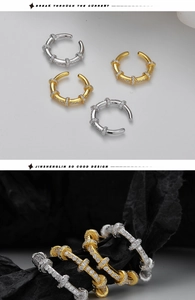 Detailed macro shot of S925 sterling silver ear cuffs with cubic zirconia inlay and hallmark