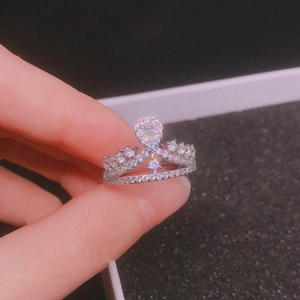 Macro detail of a silver crown-shaped ring with brilliant-cut sparkling crystals