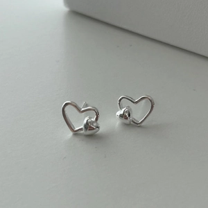 Minimalist S925 sterling silver heart-shaped stud earrings in a layered double-heart design