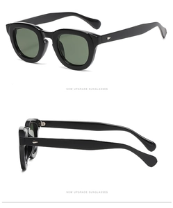 Detail view of round retro sunglasses with black frames and silver rivet decorations