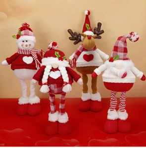 Close-up of four Christmas plush gnomes with red and white knit patterns and cute hearts