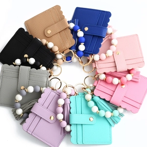 Top view of colorful scalloped edge PU leather card holder sets with beaded wristlets
