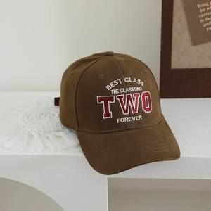 Detail of dark brown cotton baseball cap with retro TWO letter embroidery on white stand