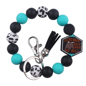 Silicone beaded keychain with cow print beads, black tassel and Do No Harm bull plaque