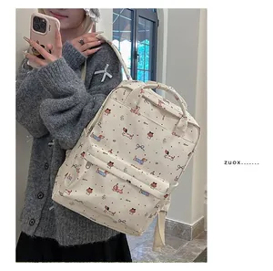 Detail of canvas backpack featuring cartoon dachshund print and front zipper pocket