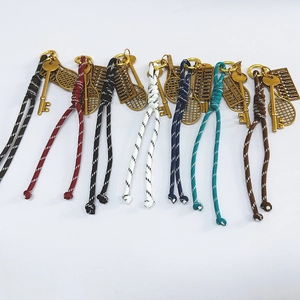 Handmade woven keychain with tennis racket and abacus charms in multiple colors