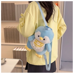 Detail of cute blue plush penguin backpack with adjustable straps and yellow bib decoration