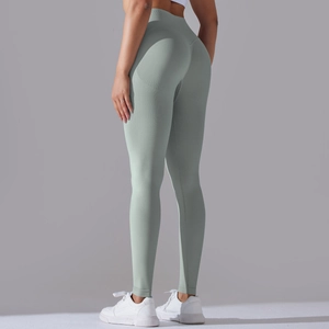 Close-up of sage green seamless yoga leggings highlighting high-waist and push-up effect