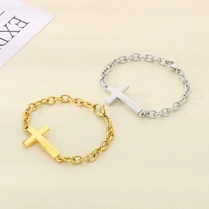 Cross pendant chain bracelets in gold and silver finish on a textured background