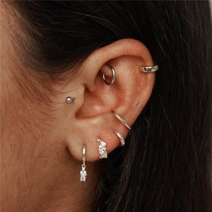 Macro view of S925 sterling silver hoop earrings set with zirconia star dangles