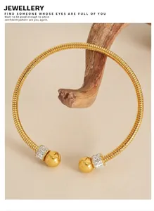 Detail of gold snake bone textured bangle with sparkling pavé rhinestone beads