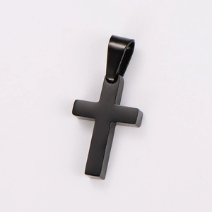 Close-up of a minimalist black stainless steel cross pendant with a polished finish
