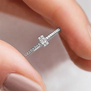 Minimalist silver zircon ring featuring a rectangular step-cut stone and pavé setting