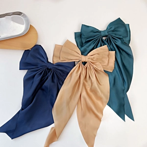 Three large silk bow hair clips with long streamers in navy, khaki, and dark green colors